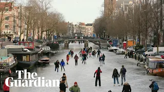 Skaters glide across frozen surfaces of Amsterdam canals