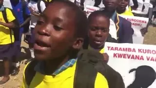 Children marching and singing against child marriage