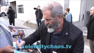 Mel Gibson helps make fans money by signing autographs for them