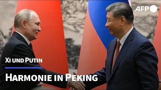 Xi und Putin präsentieren sich als Garanten des Friedens | AFP