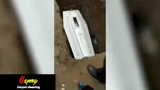 Corpse waving through glass panel in coffin