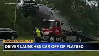 CAUGHT ON CAMERA: Driver launches car off flatbed truck