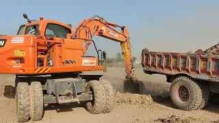 Mud Moving Marvel: Excavator Fills Trailer Trolley