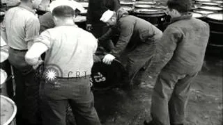 Sailors roll drums of radioactive waste material over the edge of USS Calhoun Cou...HD Stock Footage