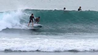 surfing friendly with the waves - bingin beach bali