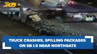 All lanes on SB I-5 near Northgate closed due to semi-truck crash, packages spilled on roadway