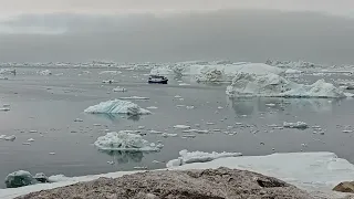 coast Guard and turist boat among iceberg