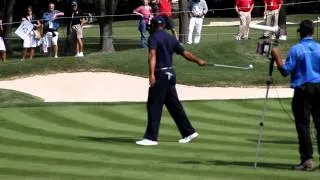 Tiger Woods picks up ball with Style