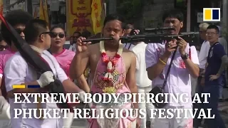 Devotees pierce faces during annual vegetarian festival in Phuket, Thailand