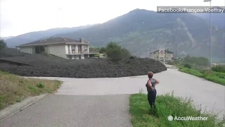 Massive mud flow slams through Swiss town