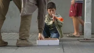 The littlest flutist, Syrian refugee boy