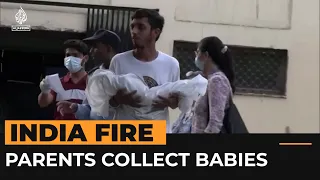 Parents collect their babies who died in New Delhi fire