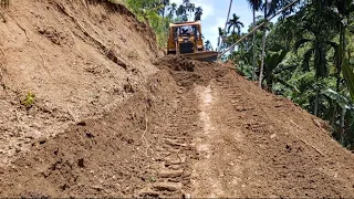 Very good job D6r Xl bulldozer cut the hill on the edge of the cliff to make a new road