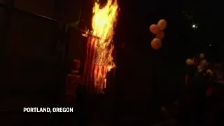 Portland protesters burn US flags, police arrive