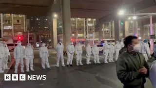 Covid lockdown protest break out in China city after deadly fire - BBC News