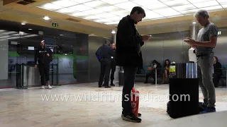 Passengers smoke inside the smoking area of Terminal 1, Lisbon Airport