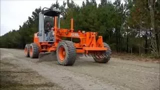 Motorgrader Spreading Stone