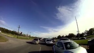 Motorcyclist lane splits through oncoming trafiic!