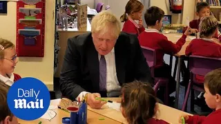 Boris Johnson talks climate change and does gardening with school children in Bristol