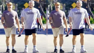Colton Underwood shows off toned forearms and sculpted calves on stroll with beau Jordan C. Brown...