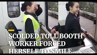 Scolded by driver,tollbooth worker forces her to smile.