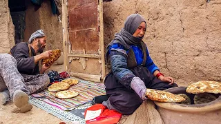 Making tandoor and baking bread in it. Afghan caveman couple