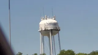 A water tower with a cluster of antennas