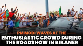 PM Modi waves at the enthusiastic crowd during the roadshow in Bikaner