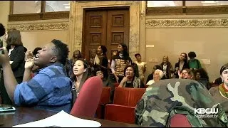 Protesters Chain Themselves Together In Oakland City Council Meeting