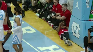 Terquavion Smith leaves on a stretcher after hard foul from UNC's Leaky Black