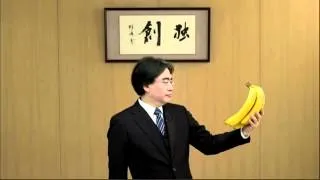 Iwata holding bananas (Nintendo E3 2012 conference)