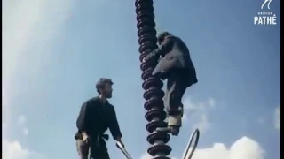 Working on a high voltage tower (1956)