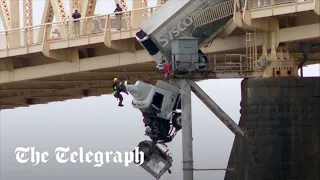 Moment driver dangles from crashed truck on Kentucky bridge