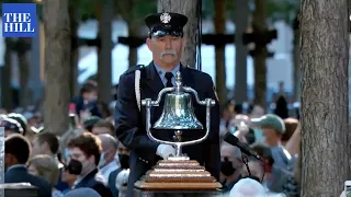 A bell is rung to mark the moment a plane into the North Tower of the World Trade Center