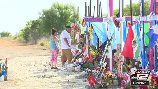 Volunteers tend to migrant memorial on Quintana Road