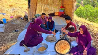 Grinding wheat in the field, blowing wheat bread by a nomadic woman