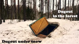 Dugout under snow, winter camping in a warm underground house. Cooked dinner on the stove