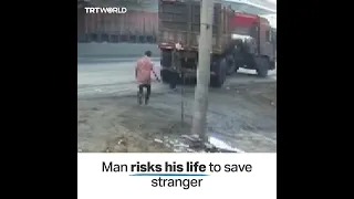 Young man saves woman at the last minute from being hit by truck in China