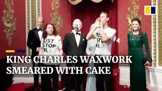 King Charles wax statue smeared with cake in climate protest targeting the art world