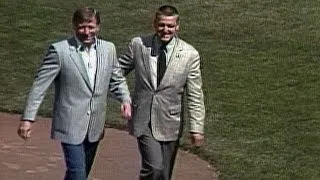 Mickey Mantle, joined by Roger Maris, tosses first pitch