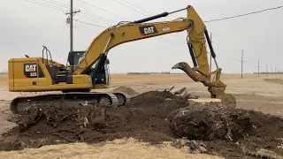 CAT 323 Excavator Digging Out a Giant Tree Stump