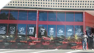 Red suv driver and man standing next to a parking spot