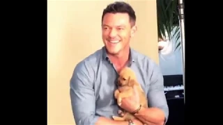 Luke Evans holding a puppy at the Toronto International Film Festival 2017