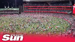 Fans invade pitch after Lance “Buddy” Franklin kicked his 1,000th Australian Football League goal