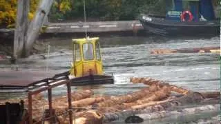 Boomboat assembling a  lograft at Jordan River on Vancouver Island.