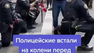 Полицейские встали на колени, перед протестующими...