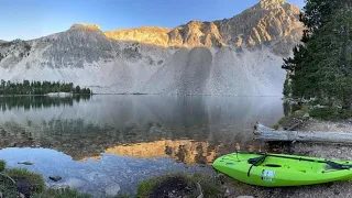 Kayak fishing beautiful high mountain lake in Idaho for trout. Catch and cook at the end