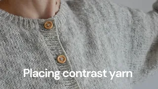 How to place contrast yarn easily on button bands.