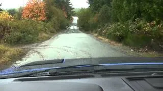 2013 Ford  SVT Raptor driving at high speed over pot holes.