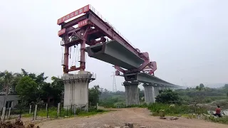 The beam truck came, the villagers around to watch the bridge erector unload the bridge